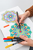 Woman colouring a mandala