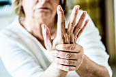 Senior woman suffering from pain in the hand