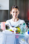 Young girl sorting recycled wastes