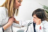 Little boy playing at being a doctor