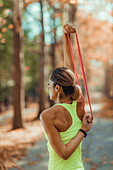 Woman exercising with resistance band outdoors