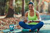 Woman looking at smart watch after outdoor training
