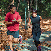 Couple jogging outdoors in park