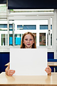 Girl holding up blank placard