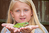 Girl holding frog