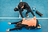 Young woman stretching after training