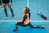 Young woman stretching after training