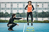 Hurdle training with personal trainer