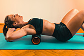 Massaging back with foam roller