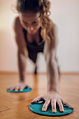 Female athlete exercising with sliding discs