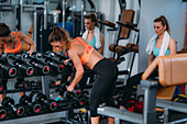Women exercising with weights in the gym