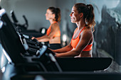 Woman exercising on elliptical cross trainer