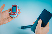 Woman entering glucose level data into app