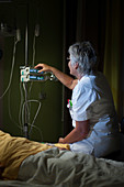 Nurse administering sedative on palliative care ward