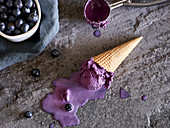 Melting vegan blueberry ice cream in a waffle cone