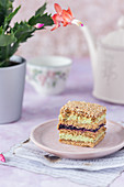 Sesame and honey cake with pistachio cream and blackcurrant jam