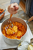 Kid preparing squash mash