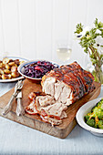 Roast pork lunch with red cabbage, mustard-glazed potatoes and broccoli