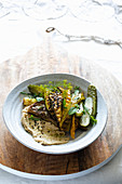 grilled zucchini over hummus with just fermented cucumbers