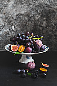 An arrangement of grapes, figs and plums