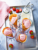 Cream and strawberry ice cream in wafer cones