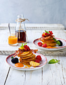 Pancakes with maple syrup, bacon and fresh fruits