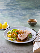 Leg of lamb with potatoes and pan-fried vegetables