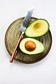 Avocado cut in half on a plate