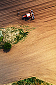 Farmer and tractor with seeder,aerial view
