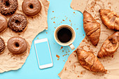 Coffee,croissants and doughnuts with smart phone