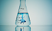 Blue liquid diffusing in flask