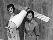 NASA scientists with a model of a Pegasus satellite, 1964