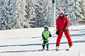 Boy having skiing lesson
