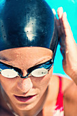 Woman in swimming cap and goggles