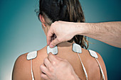 Placing TENS electrodes on shoulders