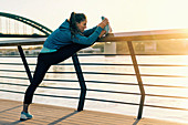 Woman stretching on bridge