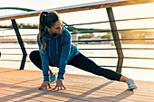 Woman stretching on bridge