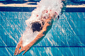 Swimmer diving into pool