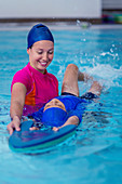 Boy having a swimming lesson with instructor