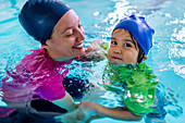 Little boy learning to swim