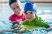 Little boy learning to swim