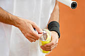 Player opening new tennis balls