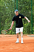 Active senior man playing tennis