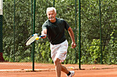 Active senior man playing tennis