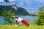 Woman doing yoga by a lake