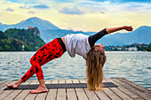 Woman doing yoga by a lake