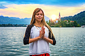 Woman doing yoga by a lake