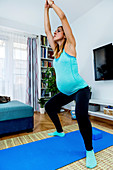 Pregnant woman doing yoga at home