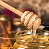 Wooden dipper with flowing honey