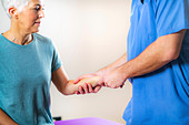 Physical therapist examining patient's wrist